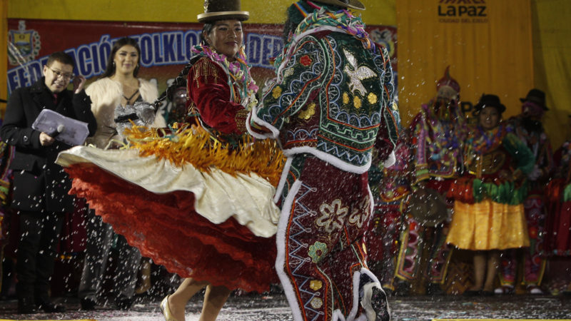 Chola and Chuta dancers perform during a competition to elect the three main beloved Carnival characters: Chuta, Pepino and Chola, all of whom represent gaiety, in La Paz, Bolivia, Wednesday, Feb. 12, 2020. The trio of Carnival royalty must be adept at spreading happiness and never tire of dancing as they attend all official Carnival events. AP Photo/RSS