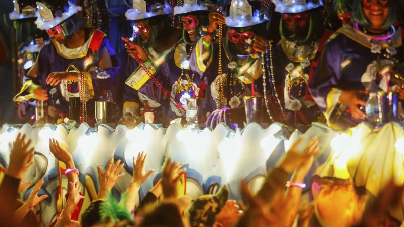 Float riders give out beads as the Mystic Krewe of Nyx parade makes its way through the streets during Mardi Gras celebrations in New Orleans, Wednesday, Feb. 19, 2020. (AP Photo/Brett Duke)