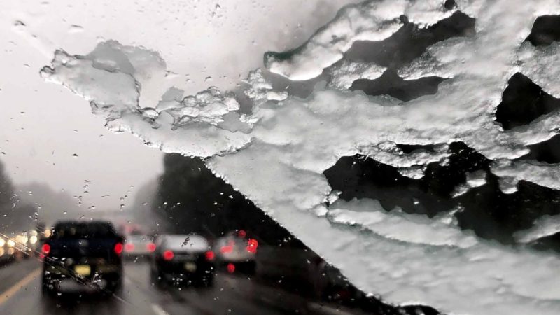 Traffic along Interstate 40 just west of Raleigh, N.C. slows to a crawl as a wintery mix falls Thursday afternoon, Feb. 20, 2020. Accumulations of 2-3 inches are expected in the area overnight. (Nicole Cvetnic/The News & Observer via AP)