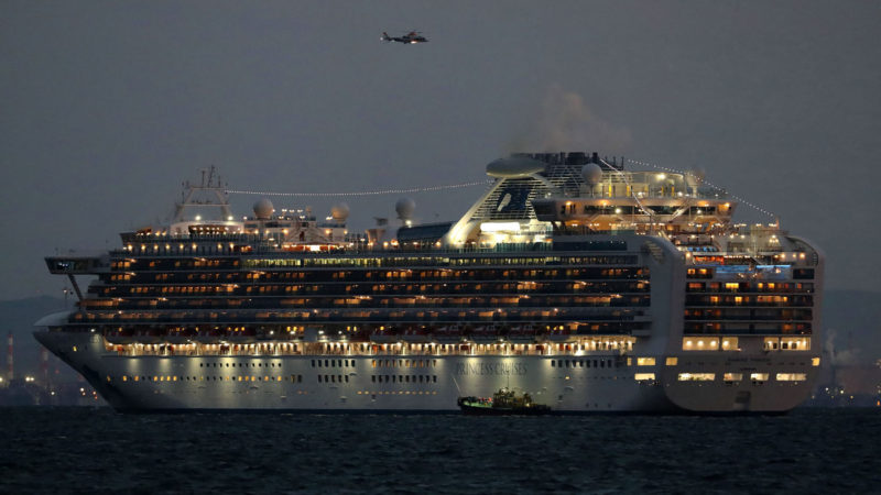 A small boat is pictured next to the Diamond Princess cruise ship with over 3,000 people as it sits anchored in quarantine off the port of Yokohama on February 4, 2020, a day after it arrived with passengers feeling ill. Photo/RSS