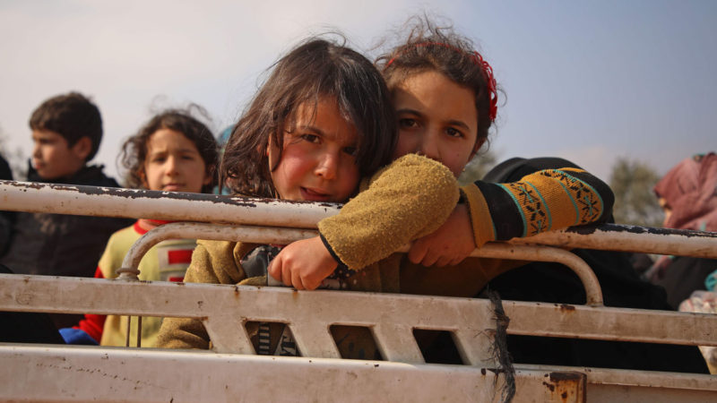 Displaced Syrian girls stand in the back of a truck parked at a newly-established camp on the edges of Maaret Misrin town in Syria's Idlib province, on February 6, 2020. - Russia-backed regime forces have pounded Syria's last major rebel bastion over the past two months, forcing more than 580,000 people from their homes and onto the roads. In a newly-established camp on the edges of Maaret Misrin, tents made available for newcomers are already packed. Designed to host 350 families, the camp is now brimming with more than 800, and people keep flooding in. Photo/ AFP