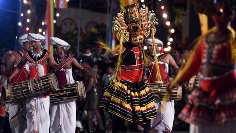 In this photo traditional dancers perform in a procession in front of the Gangarama Temple during the Navam Perahera festival in Colombo. - Monks, drummers, dancers and some 50 trained elephants thronged into Colombo from various regions of Sri Lanka to participate in the city's biggest two-day annual Buddhist procession that started on February 7. Photo/RSS