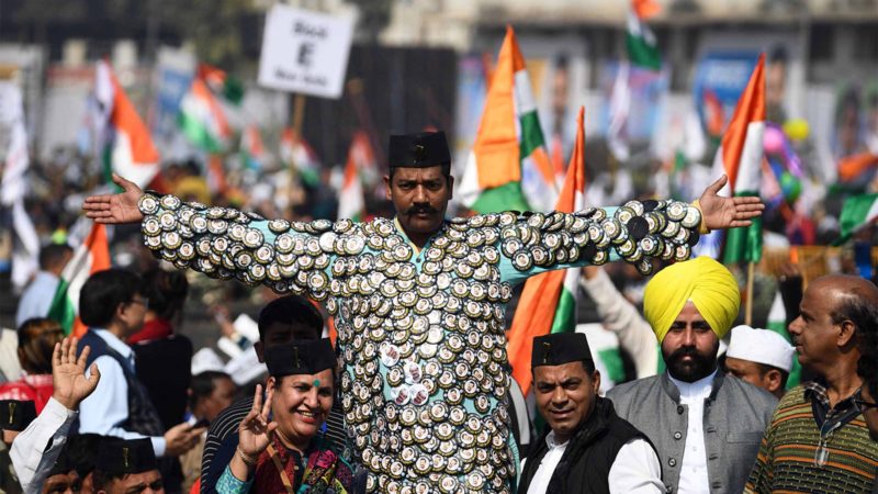 Supporters of the Aadmi Party (AAP) gesture before the swearing-in ceremony of Arvind Kejriwal as Delhi Chief Minister in New Delhi on February 16, 2020. (Photo by Sajjad  HUSSAIN / AFP)