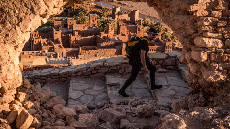 A tourist walks near the Kasbah (ancient fortress) of Ait-Ben-Haddou (background), where scenes depicting the fictional city of Yunkai from the hit HBO television series "Game of Thrones" were filmed, about 32 kilometres northwest of the city of Ouarzazate south of Morocco's High Atlas mountains on January 27, 2020. Photo/RSS