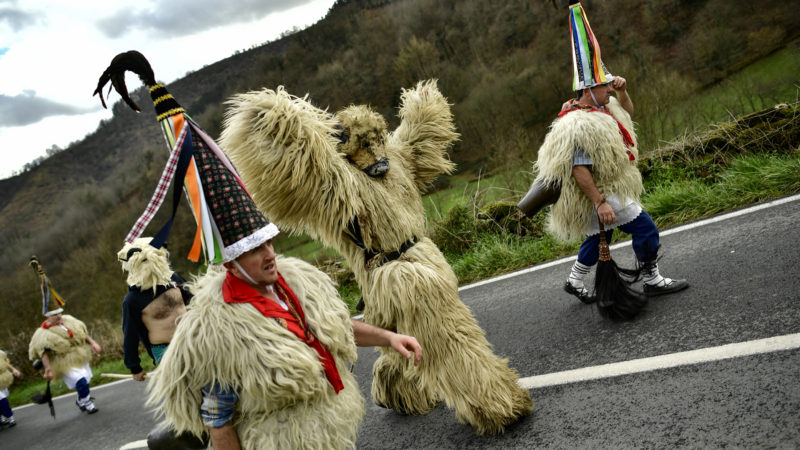 ''Joaldunaks'' walk a log the road as they take part in the Carnival, in the small Pyrenees village of Ituren, northern Spain. In one of the most ancient carnival celebrations in Europe, dozens of people don sheepskins, lace petticoats and conical caps and sling cowbells across their lower backs as they parade to herald the advent of spring. AP Photo/RSS