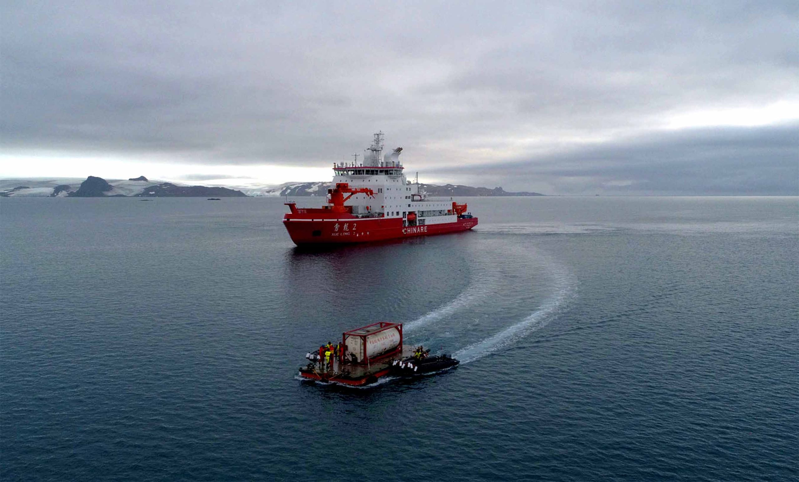 (200216) -- THE GREAT WALL STATION, Feb. 16, 2020 (Xinhua) -- Aerial photo taken on Feb. 14, 2020 shows members of China's 36th Antarctic expedition using a barge to transfer fuel from China's polar icebreaker Xuelong 2, or Snow Dragon 2, to the Great Wall station. The Xuelong 2 finished unloading supplies for the Great Wall station and left for Ross Sea. (Xinhua/Liu Shiping)