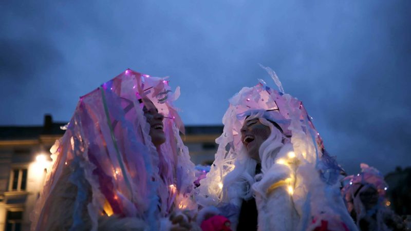 People dressed with carnival costumes laugh as they take part in the annual carnival parade in Aalst, Belgium, Sunday, Feb. 23, 2020. (AP Photo/Francisco Seco)