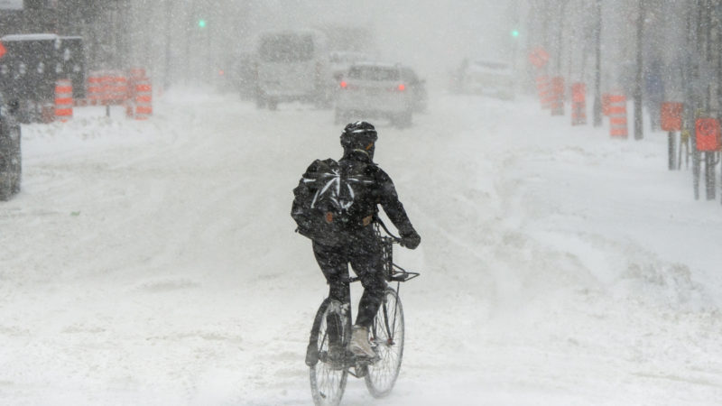 A cyclist makes his way through the blowing snow during a snowstorm, Friday, Feb. 7, 2020 in Montreal. Schools across much of southern Quebec are shuttered today as a snowstorm bears down on the province. In the Montreal area, between 11 and 19 inches of snow is expected to fall by Friday night.  Photo/RSS