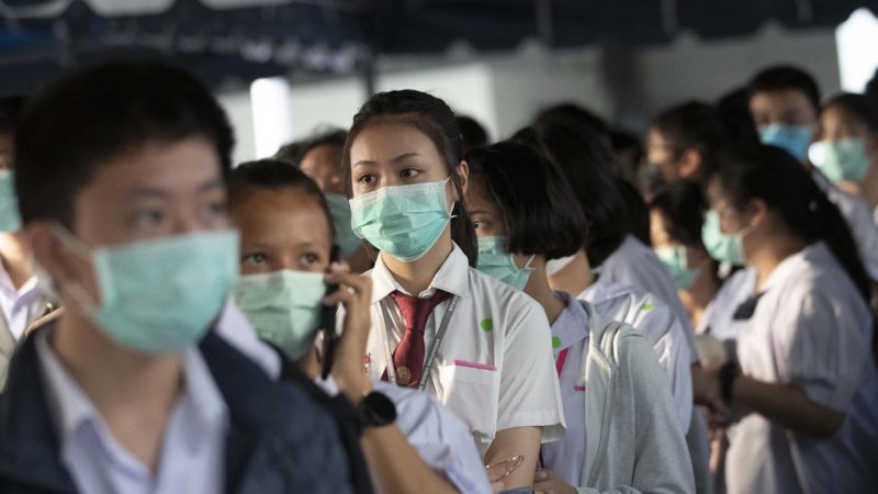 Thai students wearing protective masks line up to check temperatures before taking exams, amid fears about the spread of the COVID-19, in Bangkok, Thailand, Thursday, March 5, 2020. Thailand reported its first death form COVID -19 illness on Sunday. AP Photo/RSS