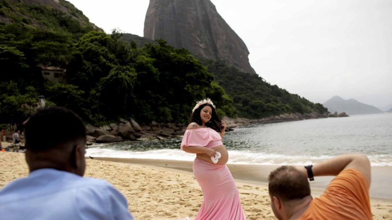 Bianca, 27, who is 9 months pregnant poses for a photo at Praia Vemelha, backdropped by the Sugar Loaf mountain, in Rio de Janeiro, Brazil, Tuesday, March 17, 2020. Rio de Janeiro’s governor Wilson Witzel declared a state of emergency, and tourist sites including Sugarloaf Mountain and the Christ the Redeemer statue are closed as a containment measure for the spread of coronavirus. The vast majority of people recover from the COVID-19 illness. (AP Photo/Silvia Izquierdo)