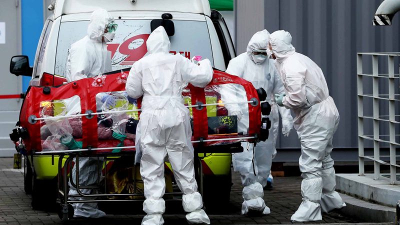 Medical staff members wearing protective gear carry a patient infected with the COVID-19 coronavirus at a hospital in Seoul on March 8, 2020. - South Korea has the highest number of confirmed COVID-19 cases in the world outside China, taking its total to 7,134. (Photo by - / YONHAP / AFP) / - South Korea OUT / REPUBLIC OF KOREA OUT  NO ARCHIVES  RESTRICTED TO SUBSCRIPTION USE
