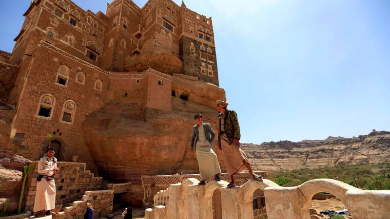 Yemenis visit the Dar al-Hajar (Rock Palace) perched atop a rock pinnacle at Wadi Dhahr valley, 15 kilometres north of Yemen's capital Sanaa, on March 13, 2020. (Photo by Mohammed HUWAIS / AFP)
