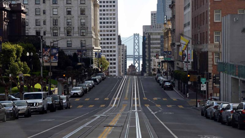 California Street, usually filled with iconic cable cars, is seen mostly empty in San Francisco, California on March 17, 2020. - Millions of San Francisco area residents last Monday were ordered to stay home to slow the spread of the deadly coronavirus as part of a lockdown effort covering a section of California including Silicon Valley. (Photo by Josh Edelson / AFP)