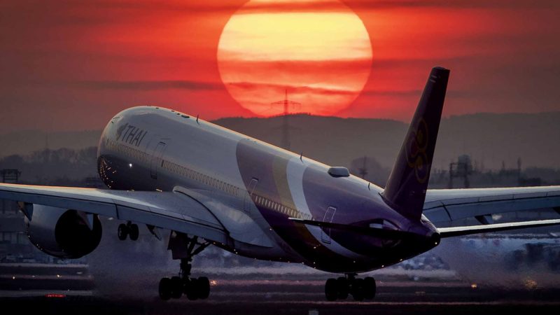 An airbus A 350 from Thai airways lands at the airport in Frankfurt, Germany, as the sun sets Tuesday, March 17, 2020. Due to the coronavirus thousands of flights had to be canceled worldwide. Only for most people, the new coronavirus causes only mild or moderate symptoms, such as fever and cough. For some, especially older adults and people with existing health problems, it can cause more severe illness, including pneumonia. (AP Photo/Michael Probst)