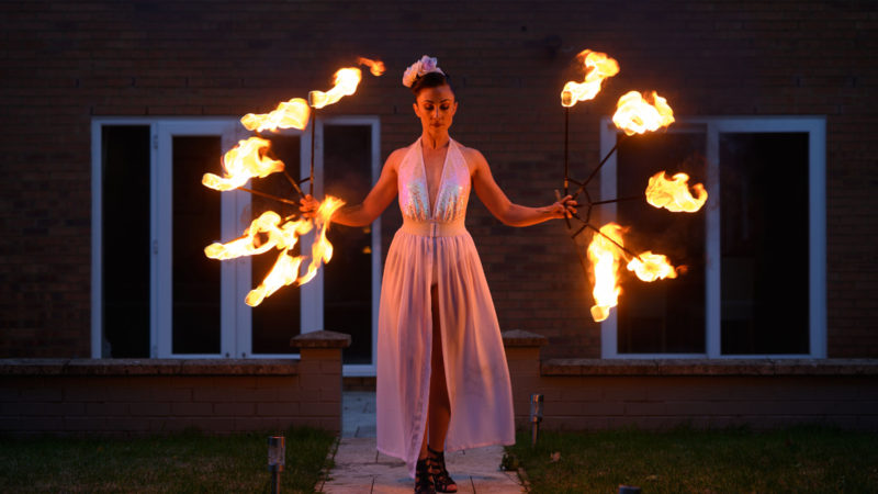 Katia McGurk, and aerial and fire performer, practices her fire skills in the garden of her home in Daventry, central England on May 23, 2020, during the novel coronavirus COVID-19 pandemic. - Following training at various circus schools, Katia McGurk began performing her aerial and fire skills in 2011. Her clients include: television, weddings, corporate functions and shows on cruise ships - all of which have been affected by the coronavirus pandemic. (Photo / RSS)