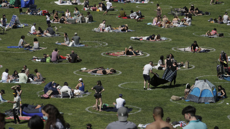 Visitors set up inside circles designed to help prevent the spread of the coronavirus by encouraging social distancing at Dolores Park in San Francisco, Sunday, May 24, 2020. (AP Photo/RSS)