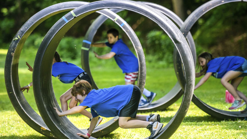 Fen Bohen, 9, of Gibsonia, participates in an obstacle course with fellow campers Thursday, June 11, 2020, at Camp Guyasuta in Sharpsburg, Pa. Camp Guyasuta's STEM Adventure Day Camp started for the summer on Monday, one of a handful of camps to open with adjusted protocols due to the COVID-19 pandemic. (Photo/RSS)