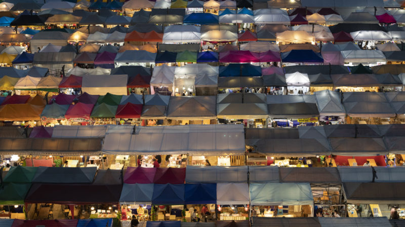 Tents of food stalls and other vendors are illuminated at Rot Fai Market in Bangkok, Thailand, Friday, June 19, 2020. Daily life in the capital resumes to normal as the government continues to ease restrictions related to running business and activities that were imposed weeks ago to combat the spread of COVID-19. Thailand reported no local transmissions of the coronavirus in the past 3 weeks. (AP Photo/RSS)
