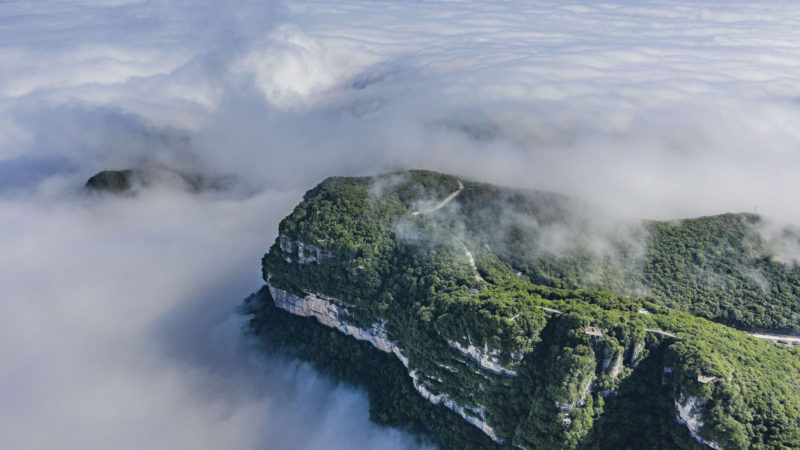 Aerial photo taken on June 10, 2020 shows clouds flowing among mountains in Longtoushan scenic area in Nanzheng District of Hanzhong, northwest China's Shaanxi Province. (Photo/RSS)