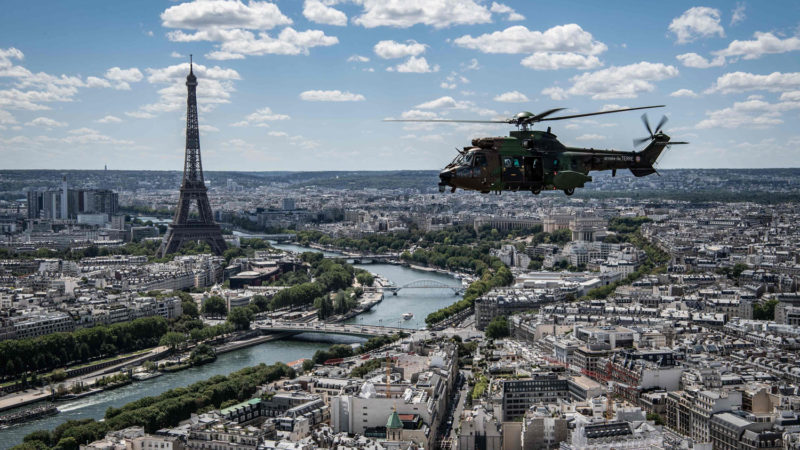 A Cougar AS532 helicopter flies over the Eiiffel Tower and the city of Paris on July 9, 2012 during the rehearsal of the Bastille Day traditional military parade on the Champs-Elysees avenue. (Photo/ RSS)