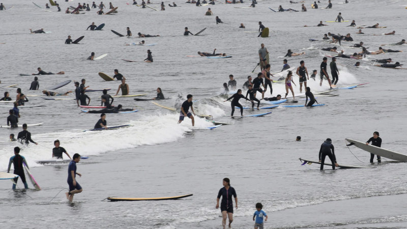 Surfers wait for a wave at a beach on a national holiday in Fujisawa, Kanagawa prefecture, near Tokyo, Thursday, July 23, 2020. (AP Photo/RSS)