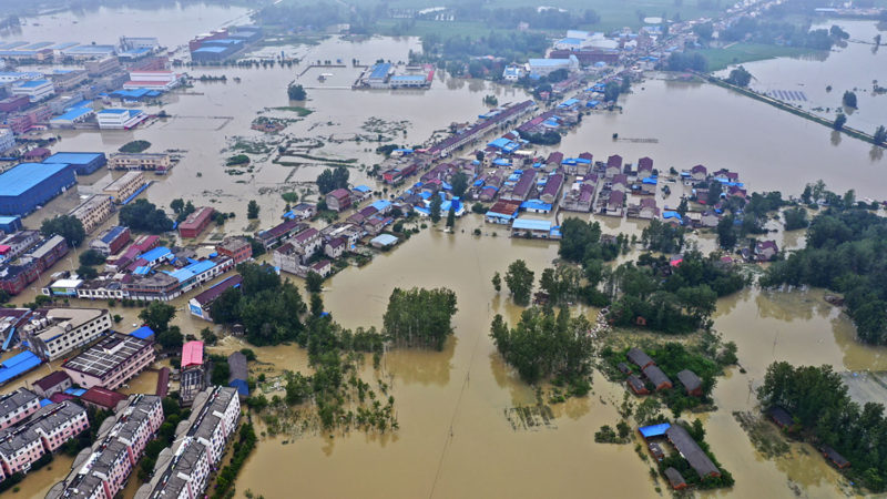 FILE - This July 20, 2020, aerial file photo released by Xinhua News Agency shows the extent of flooding in Guzhen Town of Lu'an City in eastern China's Anhui Province. Summer floods in China have left more than 200 people dead or missing and caused $25 billion in direct damages, an emergency management official said Thursday, Aug. 13, 2020. The floods struck major river systems across the central and southern parts of the country. (Tang Yang/RSS)