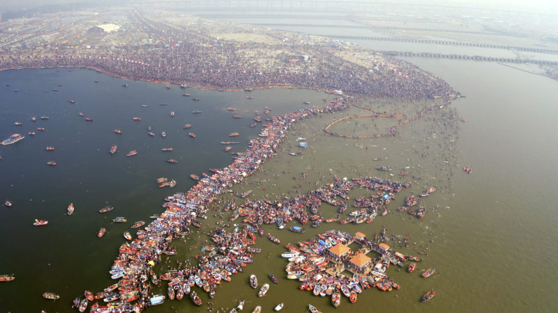 This image released by National Geographic shows a large crowd swimming in the water during a Hindu festival in India, shown in the two-part special "India from Above," narrated by actor Dev Patel. (Gaurav Agarwal/RSS)