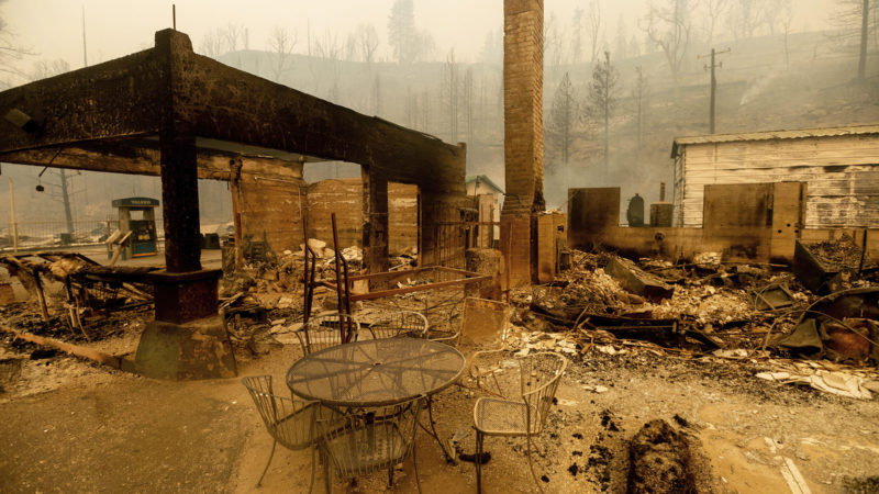 FILE - In this Sept. 8, 2020, file photo, a table stands outside the destroyed Cressman's General Store after the Creek Fire burned through Fresno County, Calif. Experts agree that more extreme fire behavior is driven by drought and worsening conditions that they attribute to climate change. Among the most concerning developments is that wildfires can spread far more quickly, leaving less time for warnings or evacuations. (AP Photo/Noah Berger, File)