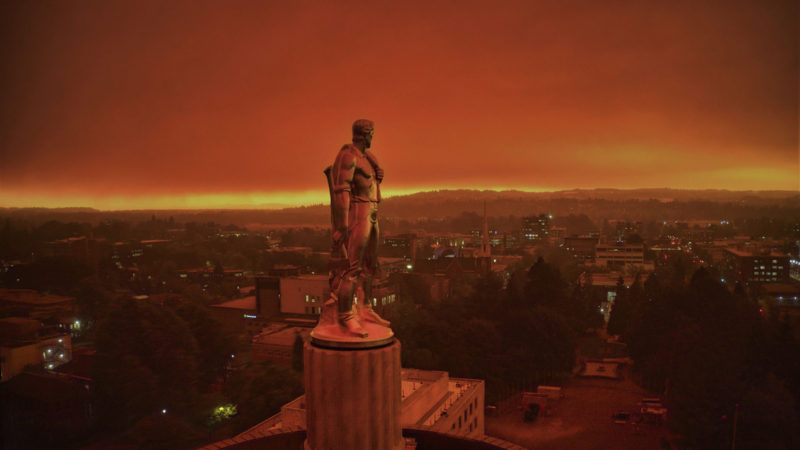 This drone photo provided by Michael Mann shows the Oregon Capitol building, with its "Oregon Pioneer" bronze sculpture atop the dome, with skies filled with smoke and ash from wildfires as a backdrop in Salem, Ore., on Sept. 8, 2020. Fires continued to rage across the West Coast on Monday, Sept. 21, 2020. (Photo/RSS)