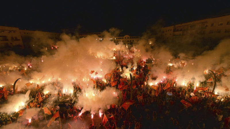 Protesters light torches during a rally in Podgorica, Montenegro, Sunday, Sept. 6, 2020. Several thousand protesters waving Montenegro flags have gathered in the state capital in support of the ruling pro-Western party which could lose power if the pro-Serb and pro-Russian groups manage to form a ruling coalition. (AP Photo/Risto Bozovic)