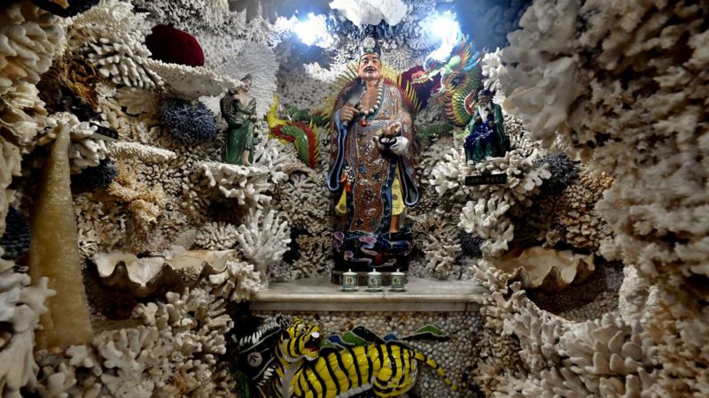 This picture shows Taoist god Ji Gong (C) at the Taoist Fufudingshan Shell and Coral Temple in New Taipei City on October 13, 2020. (Photo by Sam Yeh / AFP)