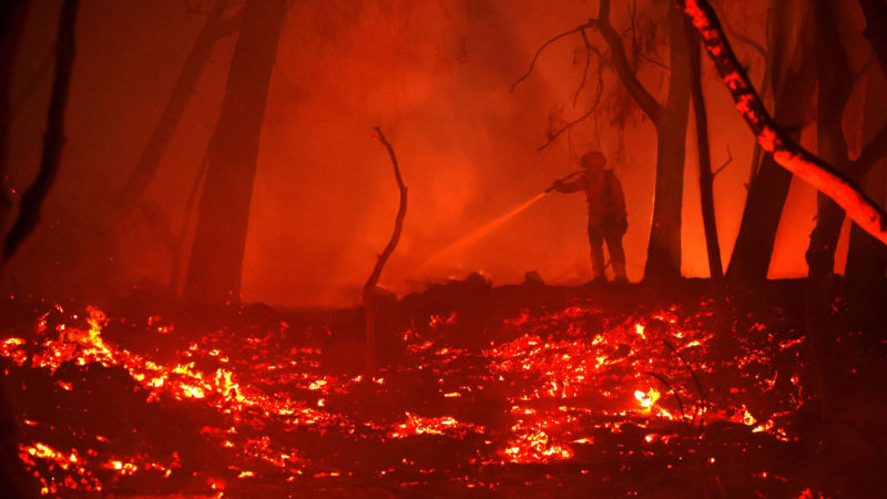 CALISTOGA, CALIFORNIA - OCTOBER 01: A firefighter sprays water on hot spots while battling the Glass Fire on October 01, 2020 in Calistoga, California. The fast moving Glass Incident Fire, originally called the Glass Fire, has burned 56,000 acres in Sonoma and Napa counties and has destroyed numerous wineries and structures. The fire is five percent contained.   Justin Sullivan/Getty Images/AFP  == FOR NEWSPAPERS, INTERNET, TELCOS & TELEVISION USE ONLY ==