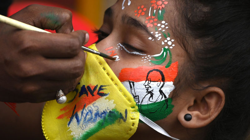 A student gets a her face painted to condemn the alleged gang-rape of 19-year-old woman victim by four men in Bool Garhi village of Uttar Pradesh state, in Mumbai on October 2, 2020. - Indian police have been ordered to provide protection to the "untouchable" family of a woman allegedly gang-raped and killed by four upper-caste men, as her brother said they feared for their lives. The 19-year-old was attacked in mid-September and died this week, sparking outrage and shining the spotlight again on the alarming levels of sexual violence against Indian women, particularly if they are low-caste. Photo/RSS