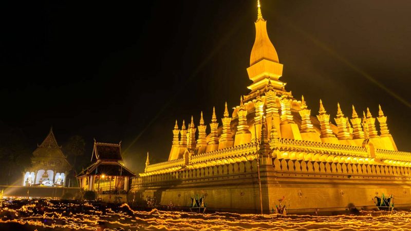 (201007) -- VIENTIANE, Oct. 7, 2020 (Xinhua) -- People pray around the That Luang Stupa in Vientiane, Laos, on Nov. 11, 2019.
 Laos is the only landlocked country in Southeast Asia. In the central part of the country, the capital Vientiane is located on the alluvial plain on the Mekong River, suitable for fishing and plantation.
 The Lan Xang Kingdom, the first unified multi-ethnic nation in the history of Laos, moved its capital to Vientiane in the mid-16th century, and Vientiane gradually prospered. (Photo by Kaikeo Saiyasane/Xinhua)