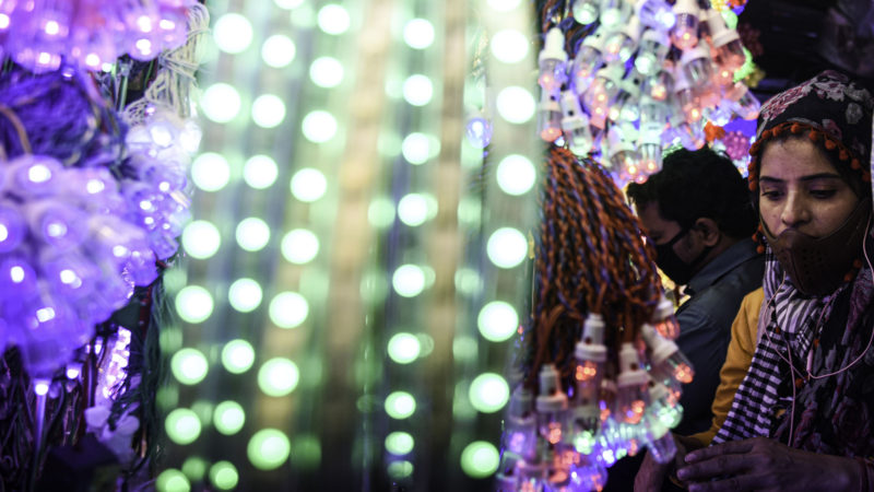 People look at electric lights at a market before Diwali, the Hindu festival of lights, amid the spread of the COVID-19 in Mumbai, India, on Nov. 12, 2020. (Photo/Xinhua)