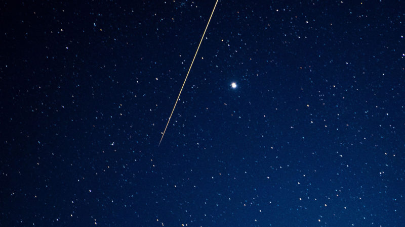 A long exposure shows the light trail of a re-entry capsule, carrying samples collected from a distant asteroid after being released by Japanese space probe Hayabusa-2, entering the Earth's atmosphere as seen from Coober Pedy in South Australia early on December 6, 2020. (Photo by Morgan Sette / AFP)