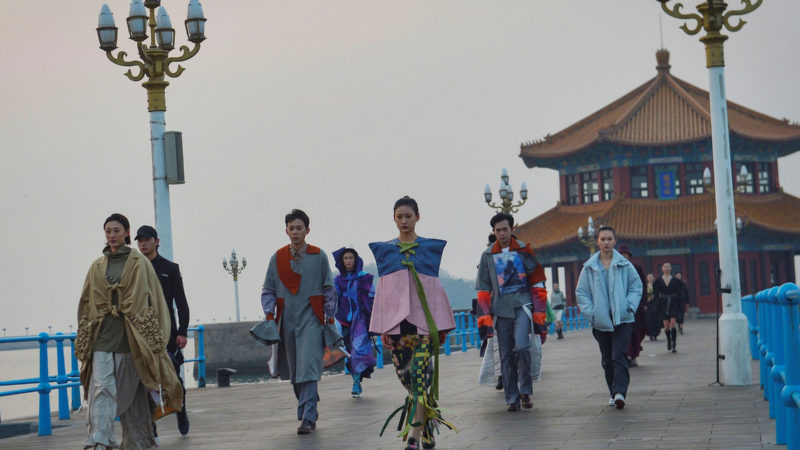 Models parade on a bridge during the World University Student Fashion Design Competition in Qingdao, in eastern China's Shandong province on December 18, 2020. (Photo by STR / AFP) / China OUT