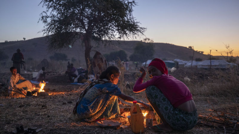 Tigrinyan refugee women prepare bread for their family in Umm Rakouba refugee camp in Qadarif, eastern Sudan, Friday, Dec. 11, 2020. (AP Photo/RSS)