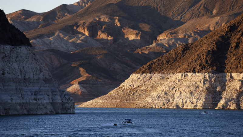 A bathtub ring of light minerals shows the high water line near Hoover Dam on Lake Mead at the Lake Mead National Recreation Area in Nevada. A set of guidelines for managing the Colorado River helped several states through a dry spell, but it's not enough to keep key reservoirs in the American West from plummeting amid persistent drought and climate change, according to a U.S. report released Friday, Dec. 18, 2020. (AP Photo/RSS)