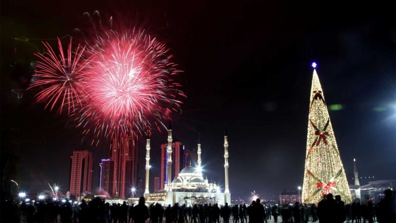 Fireworks explode over a not-too-crowded square with a Christmas tree and and the main mosque during New Year's celebrations in Grozny, Russia, late Thursday, Dec. 31, 2020. As the world says goodbye to 2020, there will be countdowns and live performances, but no massed jubilant crowds in traditional gathering spots like the Champs Elysees in Paris and New York City's Times Square this New Year's Eve. The virus that ruined 2020 has led to cancelations of most fireworks displays and public events in favor of made-for-TV-only moments in party spots like London and Rio de Janeiro. (AP Photo/Musa Sadulayev)