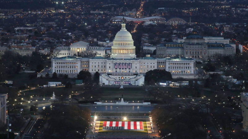 The US Capitol Building is prepared for the inauguration ceremonies for President-elect Joe Biden as the "Field of Flags" are placed on the ground on the National Mall on January 18, 2021 in Washington, DC. - Approximately 191,500 US flags will cover part of the National Mall and will represent the American people who are unable to travel to Washington, DC for the inauguration. (Photo by Joe Raedle / POOL / AFP)