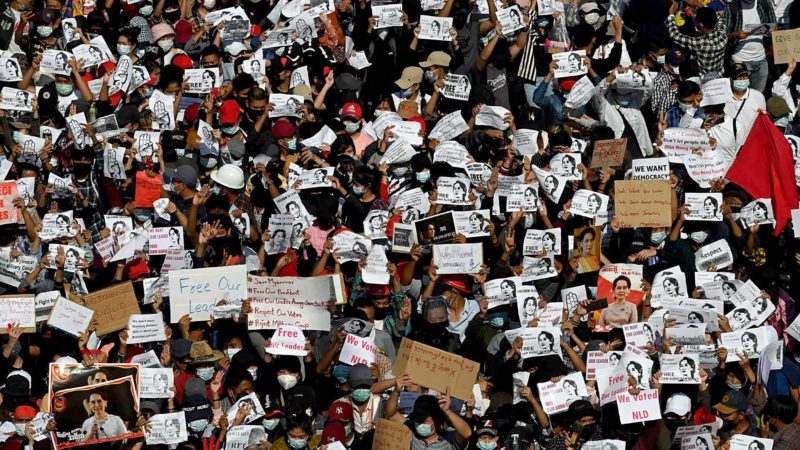 Protesters hold signs demanding the release of detained Myanmar leader Aung San Suu Kyi during a  demonstration against the military coup in Yangon on February 9, 2021. (Photo by Sai Aung Main / AFP)