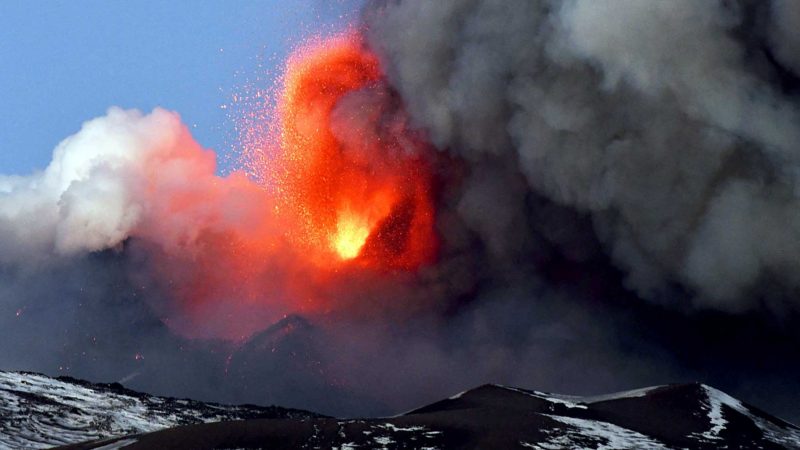 This photo obtained from Italian news agency ANSA shows the Etna volcano in Catania, Sicily, on February 16, 2021 during a spectacular eruption and a strong explosive activity from the south-east crater and the emission of a high cloud of lava ash that disperses towards the south. (Photo by Handout / ANSA / AFP) / Italy OUT