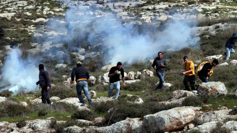 (210206) -- NABLUS, Feb. 6, 2021 (Xinhua) -- Palestinian protesters run to take cover from tear gas canisters fired by Israeli soldiers during clashes following a protest against the expansion of Jewish settlements in the West Bank village of Beit Dajan, east of Nablus, Feb. 6, 2021. (Photo by Nidal Eshtayeh/Xinhua)