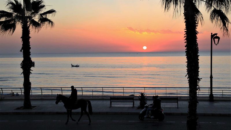 (210223) -- BEIRUT, Feb. 23, 2021 (Xinhua) -- People enjoy the sunset at a beach in Beirut, Lebanon, Feb. 22, 2021. (Xinhua/Liu Zongya)