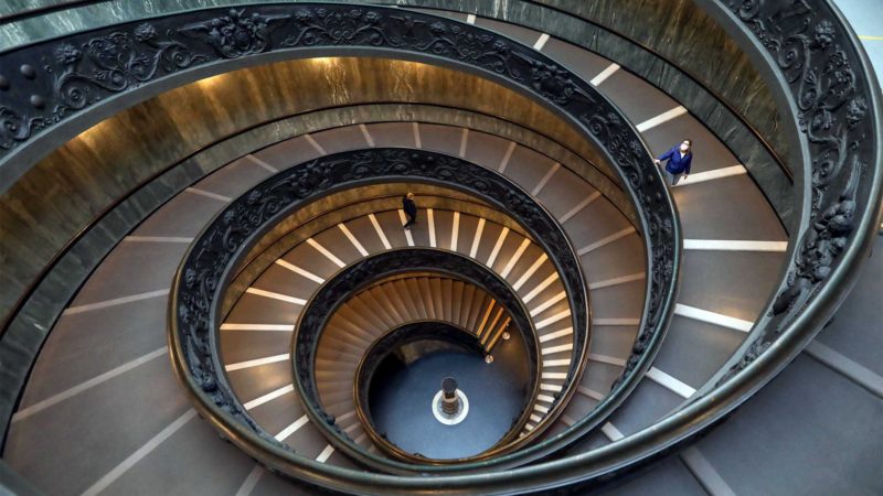 (210207) -- BEIJING, Feb. 7, 2021 (Xinhua) -- A visitor wearing a face mask walks down the staircase of Vatican Museums, on Feb. 5, 2021. The Vatican Museums, previously closed due to the COVID-19 outbreak, reopened as of Feb. 1, while visitors are required to make appointments on-line before arrival. (Xinhua/Cheng Tingting)