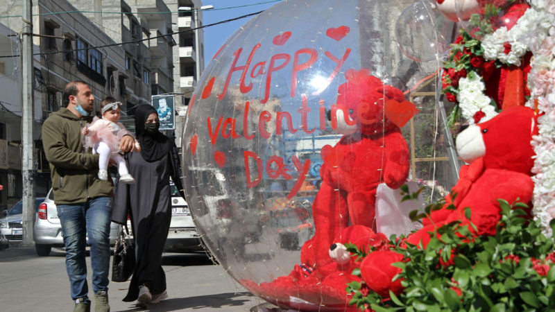 People walk in front of a shop displaying Valentine's day decorations in Gaza City, on Feb. 14, 2021. (Photo \RSS