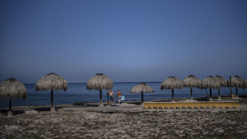 Tourists stand along the beach shore in Havana, Cuba, Tuesday, March 2, 2021. The Caribbean is hunting for visitors to jump-start the stalled economy in one of the worlds most tourism-dependent regions. (AP Photo/Ramon Espinosa)