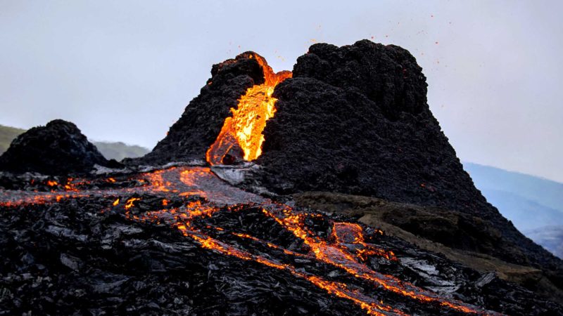 Lava flows from the erupting Fagradalsfjall volcano some 40 km west of the Icelandic capital Reykjavik, on March 21, 2021. - Weekend hikers took the opportunity Sunday to inspect the area where a volcano erupted in Iceland on March 19, some 40 kilometres (25 miles) from the capital Reykjavik, the Icelandic Meteorological Office said, as a red cloud lit up the night sky and a no-fly zone was established in the area. (Photo by Jeremie RICHARD / AFP)