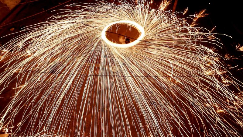 A Palestinian youth swings a homemade fireworks sparkler, as people celebrate on the night ahead of the Muslim holy fasting month of Ramadan, in Gaza City on April 11, 2021. (Photo by MAHMUD HAMS / AFP)